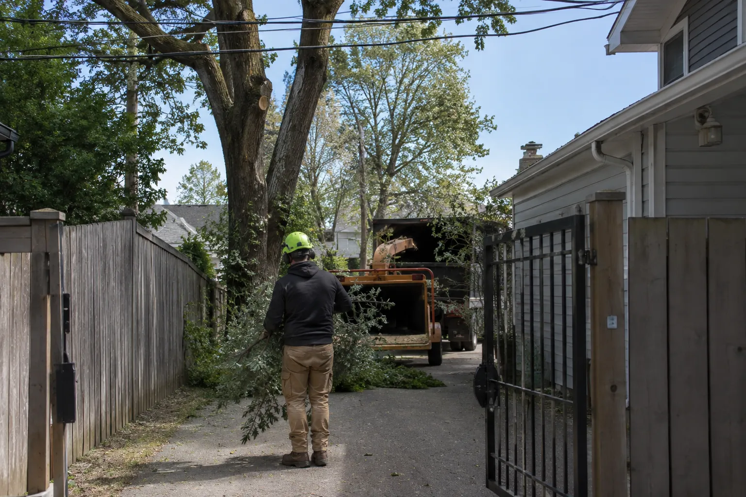 Narrow driveway with gate and overhead power lines showing site access challenges